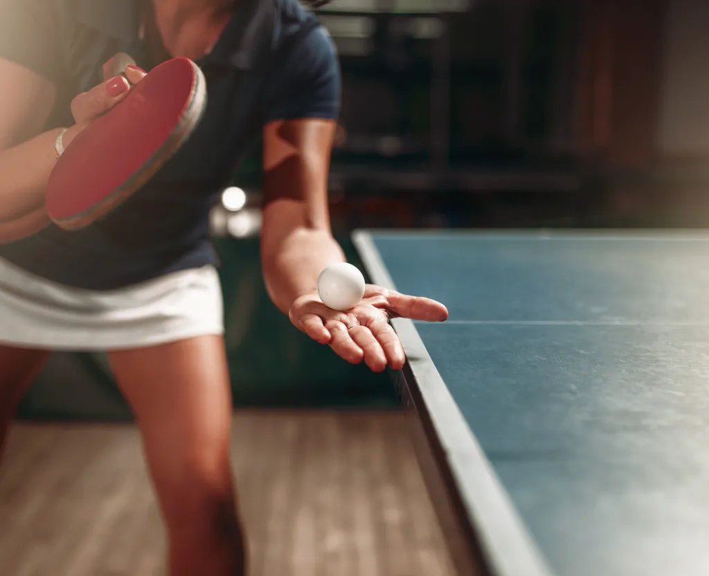 A player preparing to serve at an unmanned ping pong center running ZeroEyes